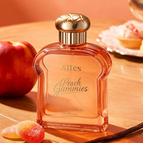 Sttes Peach Gummies Eau de Parfum bottle with fruity background