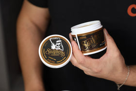 Suavecito Pomade Firme Hold 4 oz on a grooming table