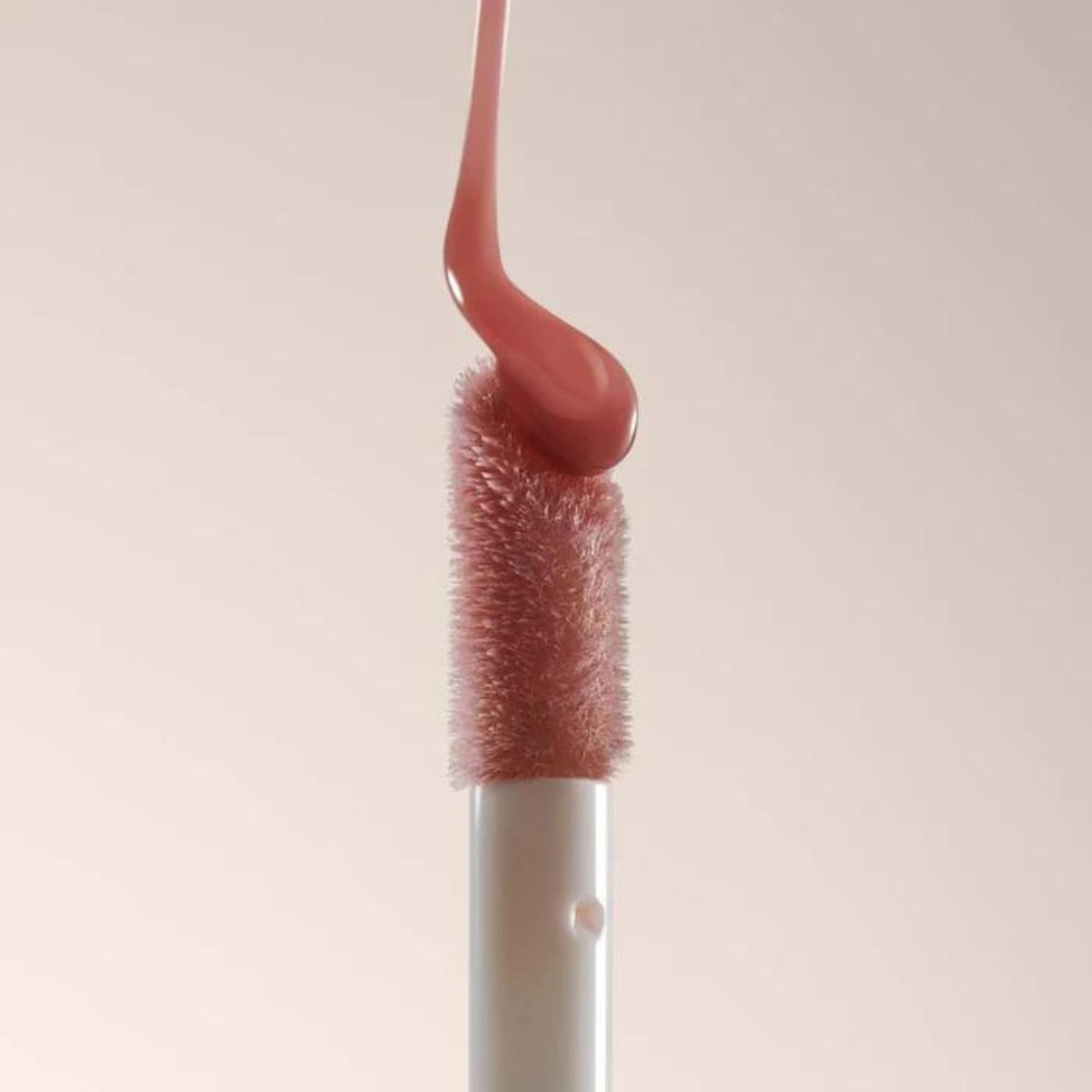 Summer Fridays Dream Lip Oil on a vanity with flowers