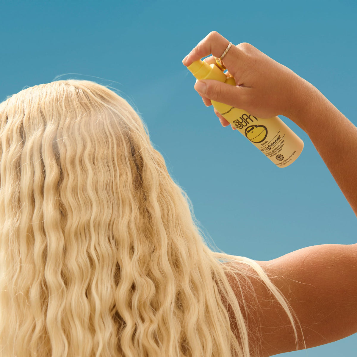 Sun Bum Hair Lightener Spray application on hair