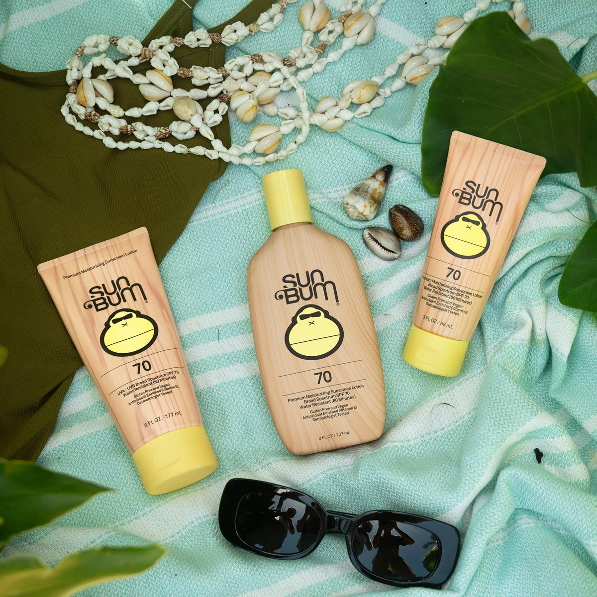Sun Bum Original SPF 70 Sunscreen Body Lotion 8 oz with beach background