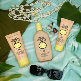 Sun Bum Original SPF 70 Sunscreen Body Lotion 8 oz with beach background
