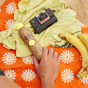 Sun Bum sunscreen spray application on skin