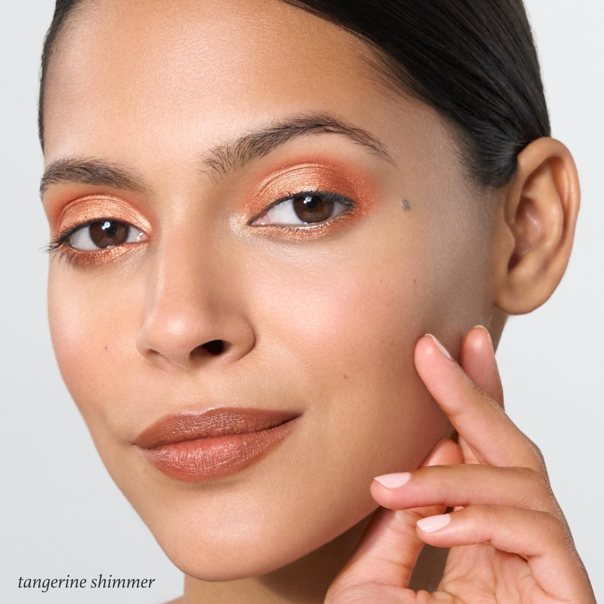 Swatch of Julep tangerine shimmer eyeliner on skin