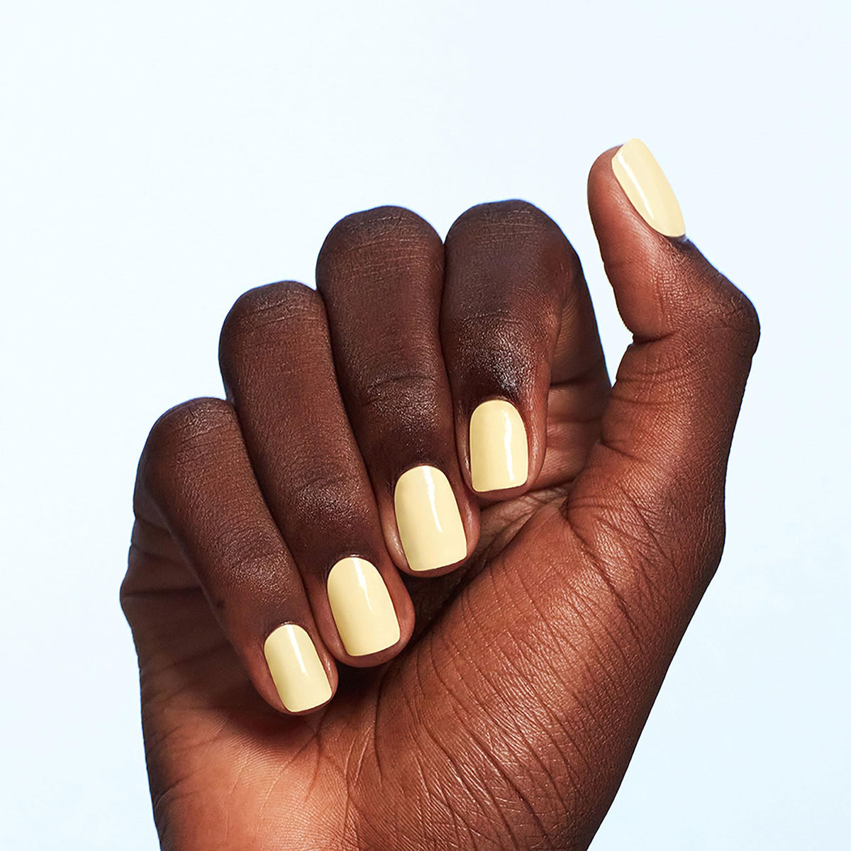 Swatch of OPI soft yellow nail polish on nails