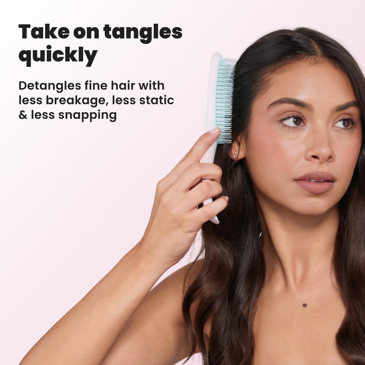 TANGLE TEEZER brush in a hand demonstrating its size