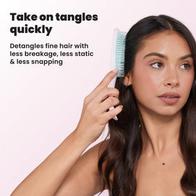 TANGLE TEEZER brush in a hand demonstrating its size