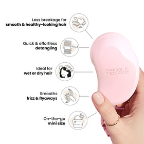 TANGLE TEEZER Mini Detangler Brush in hand for size comparison