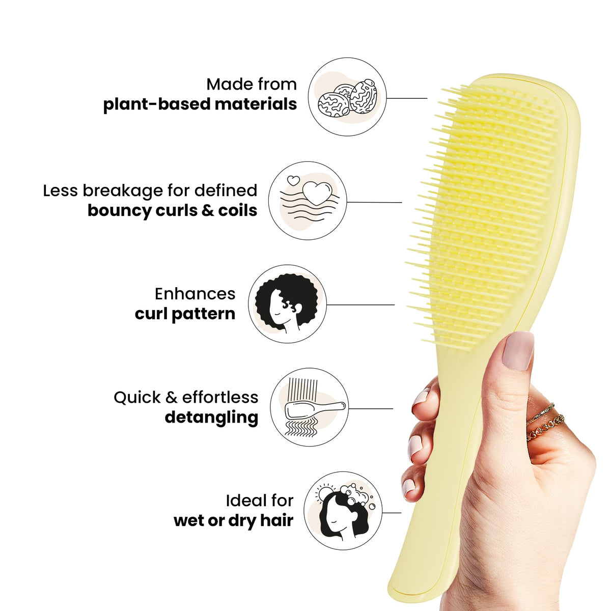 TANGLE TEEZER Plant-Based Ultimate Detangler in hand with curly hair
