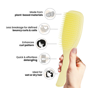 TANGLE TEEZER Plant-Based Ultimate Detangler in hand with curly hair