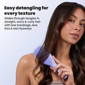 TANGLE TEEZER Ultimate Detangler Brush displayed with hair products
