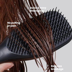 TANGLE TEEZER Ultimate Detangler Brush in hand demonstrating use