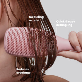 TANGLE TEEZER Ultimate Detangler Brush in hand demonstrating use