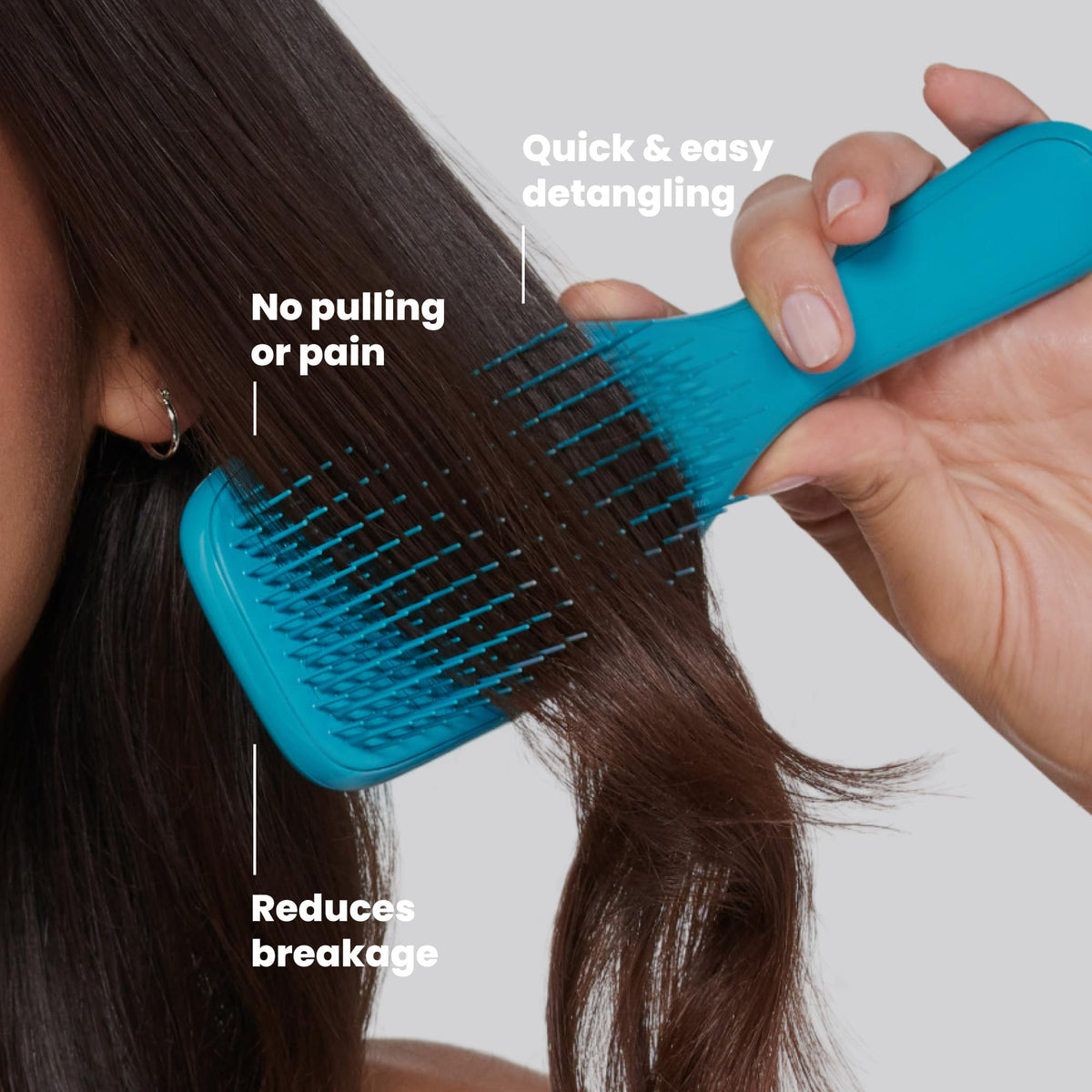 TANGLE TEEZER Ultimate Detangler Brush in hand demonstrating use