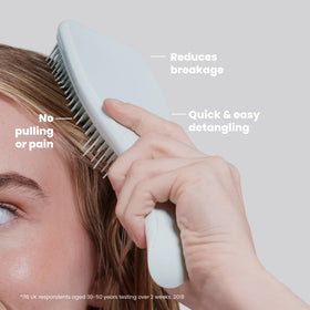TANGLE TEEZER Ultimate Detangler Brush in hand, detangling hair