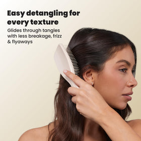 TANGLE TEEZER Ultimate Detangler Brush lifestyle scene with hair products