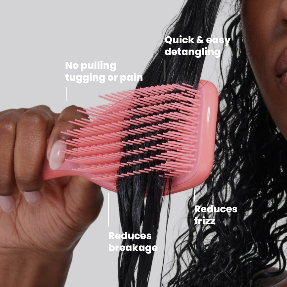 TANGLE TEEZER Ultimate Detangler Curly Hair Brush in hand demonstrating use