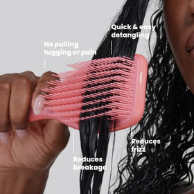 TANGLE TEEZER Ultimate Detangler Curly Hair Brush in hand demonstrating use