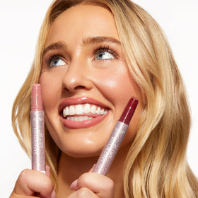 tarte Maracuja Juicy Lip Balm Duo displayed with tropical fruits