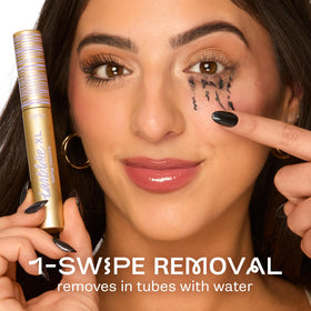tarte Tartelette XL Tubing Mascara on a vanity with makeup brushes