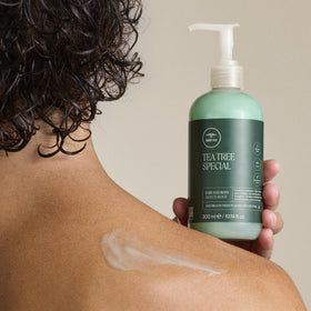 Tea Tree Hair and Body Moisturizer on a bathroom shelf