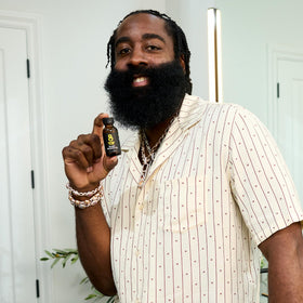 The Beard Club Beard Growth Oil beside grooming tools