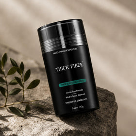 Thick Fiber Hair Building Fibers Medium Brown 12g on a bathroom counter