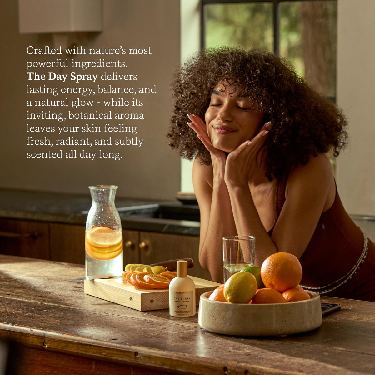 Third Layer Day Spray Body Oil on a wooden surface with natural elements