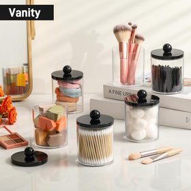 Three acrylic jars with assorted beauty items inside