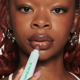 Topicals Slick Salve Mint Lip Balm on a wooden table