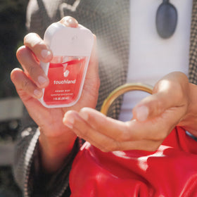 Touchland hand sanitizer set displayed on a wooden table