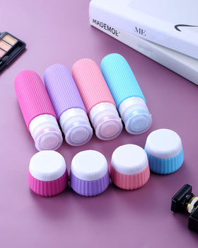 Travel containers for toiletries in a clear makeup bag