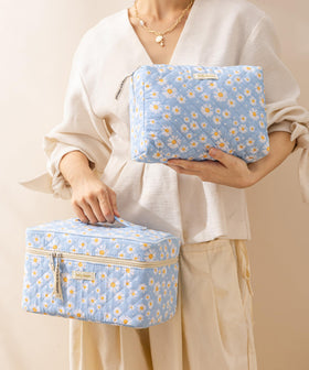 Travel-ready HBselect makeup bags in a suitcase