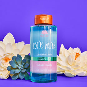 Tree Hut Body Wash with fresh lotus flowers in background