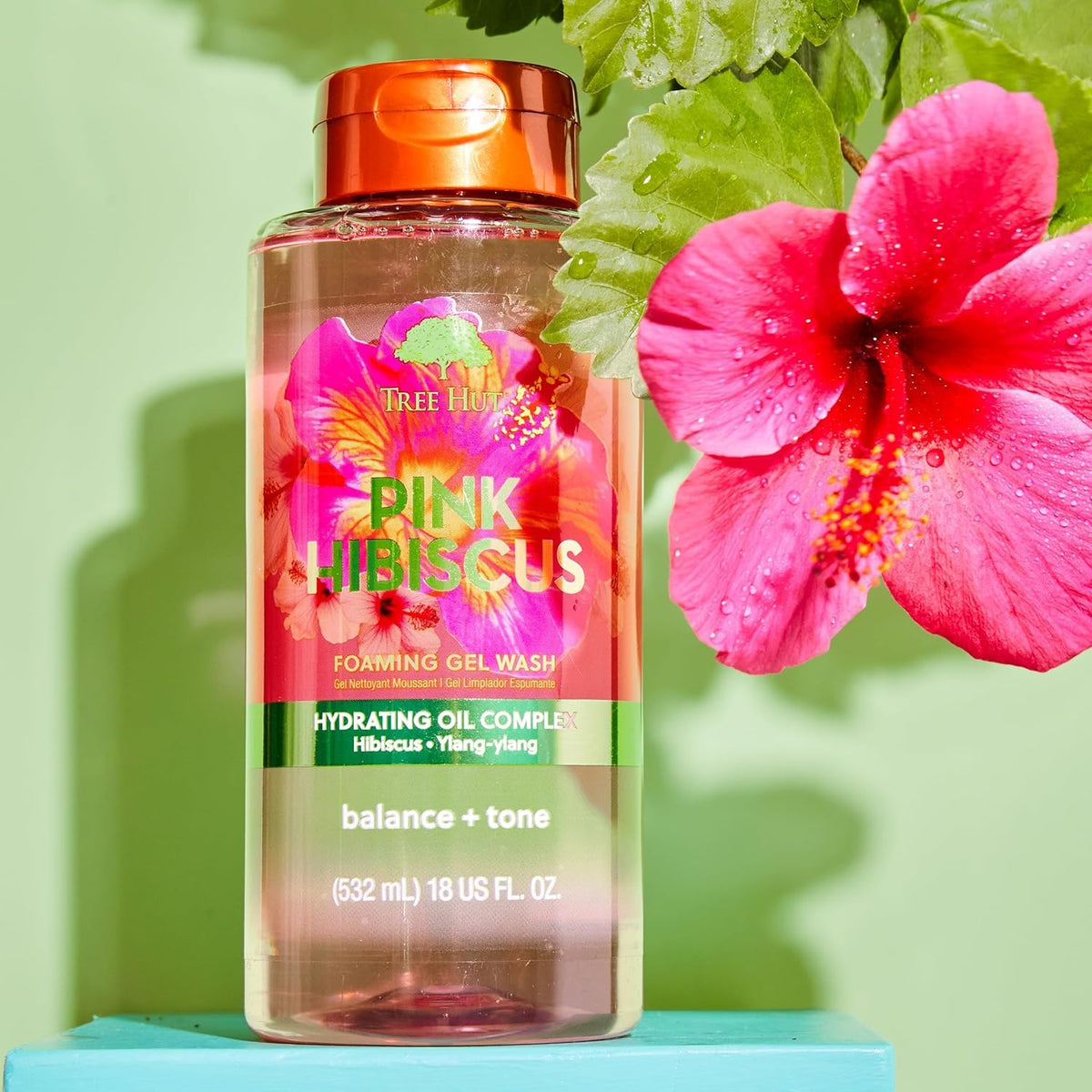 Tree Hut Pink Hibiscus Body Wash with floral background