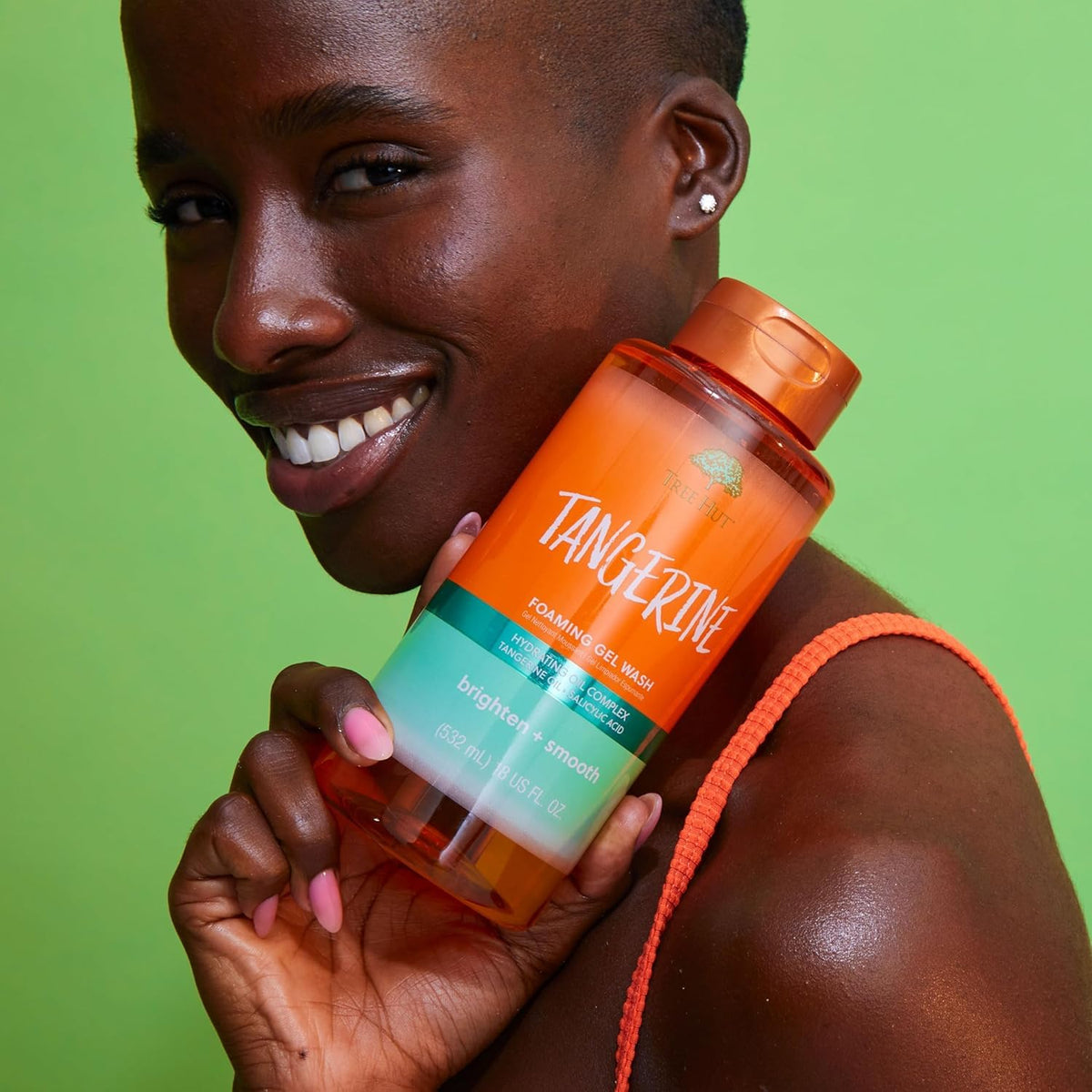 Tree Hut Tangerine Body Wash pouring into hands