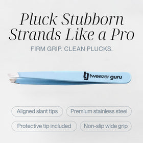 TWEEZER GURU eyebrow tweezers on a vanity with beauty products