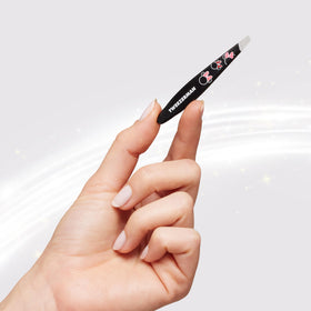 Tweezerman Minnie Mouse Mini Slant Tweezer with background of beauty products