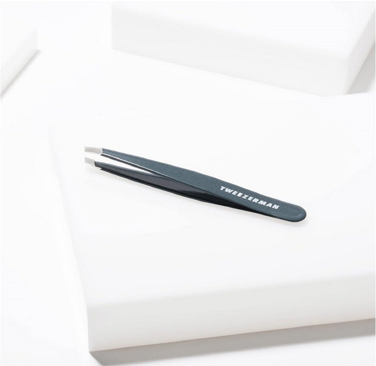 Tweezerman Slant Tweezer blue stone on vanity