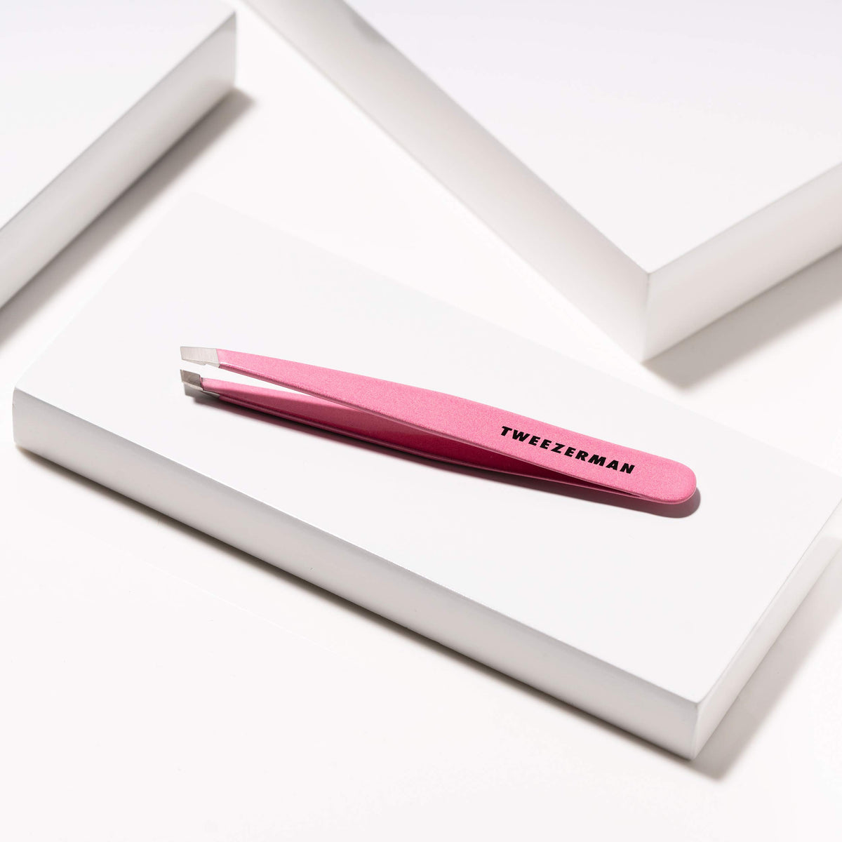 Tweezerman Slant Tweezer in hand demonstrating use