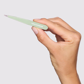 Tweezerman Slant Tweezer Pistachio on a vanity