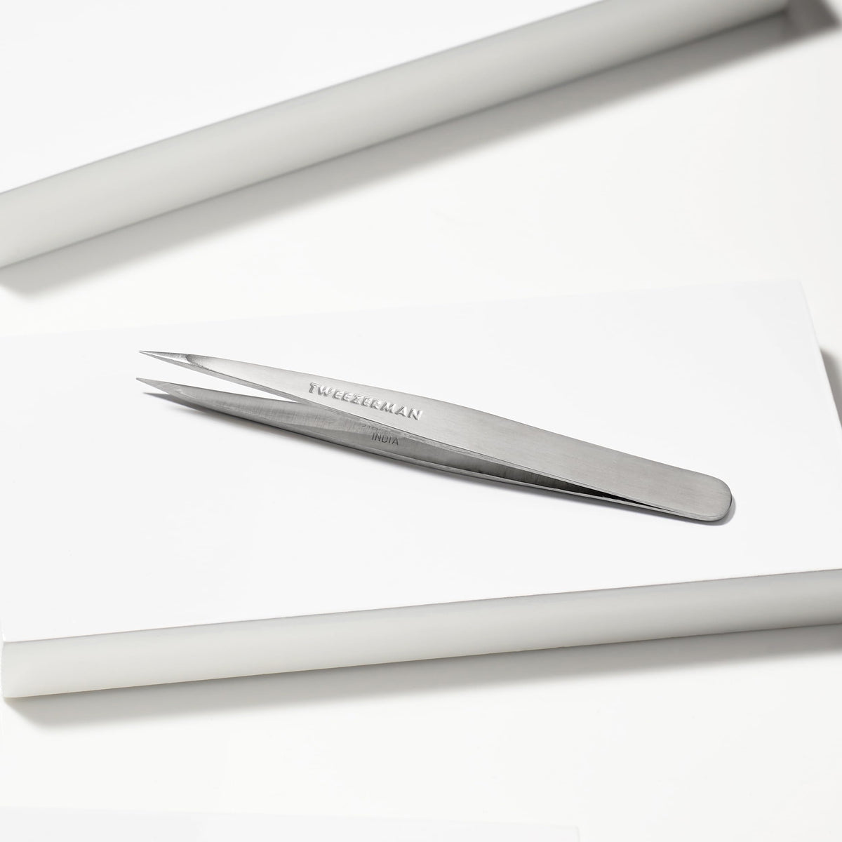 Tweezerman Steel Point Tweezer in hand for eyebrow grooming
