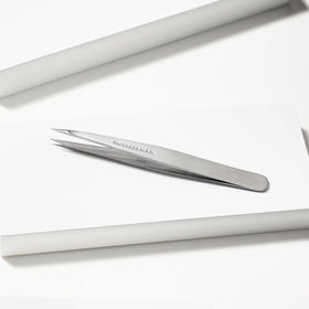 Tweezerman Steel Point Tweezer in hand for eyebrow grooming