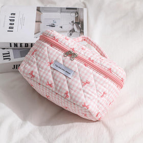 uekeboag Large Travel Quilted Makeup Bag opened with cosmetics inside