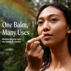 User applying Dr. Bronner's Organic Lip Balm on lips