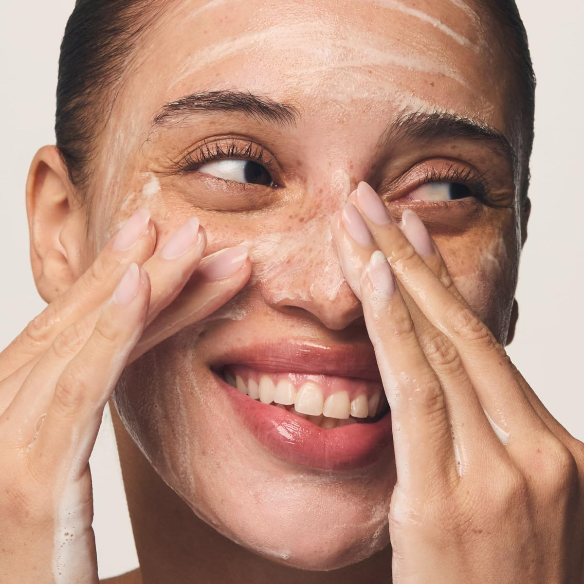 User applying Prequel Skin Redness Reform Cleanser in bathroom