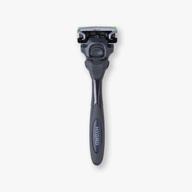 User demonstrating Schick Hydro Sensitive razor in bathroom