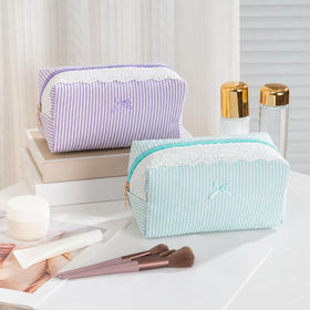 UUYUUY Makeup Bag compact size next to a phone
