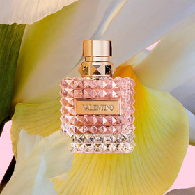 Valentino Donna Eau De Parfum bottle with floral background