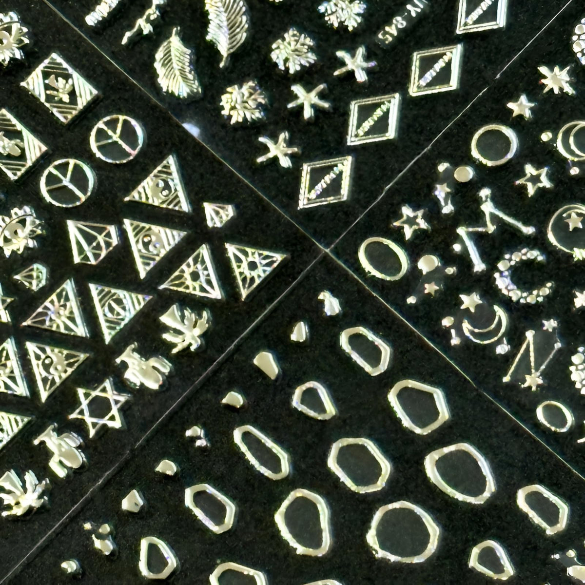 Variety of SPLOCUDU silver nail stickers including leaves and snowflakes